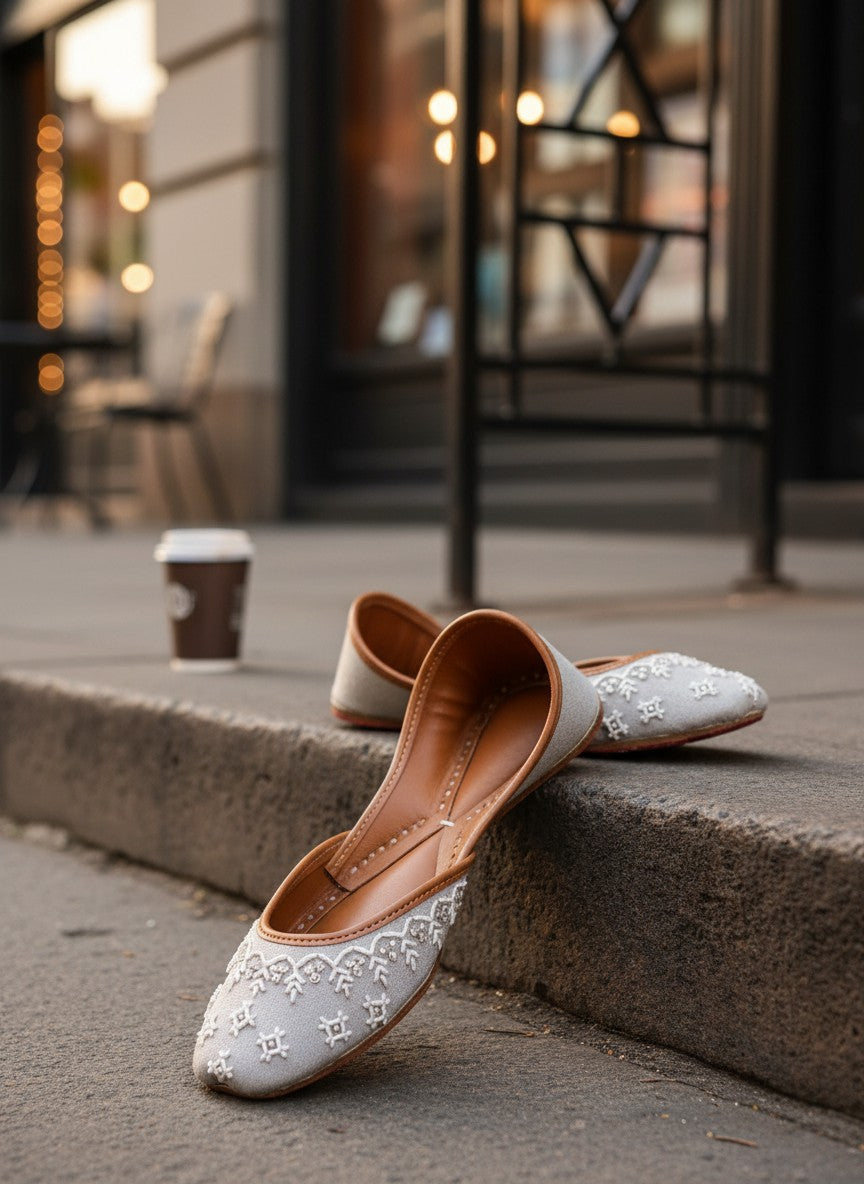Ujaala Roshan grey jutti with white embroidery and brown leather lining.