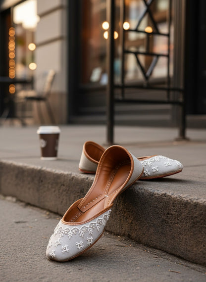 Ujaala Roshan grey jutti with white embroidery and brown leather lining.