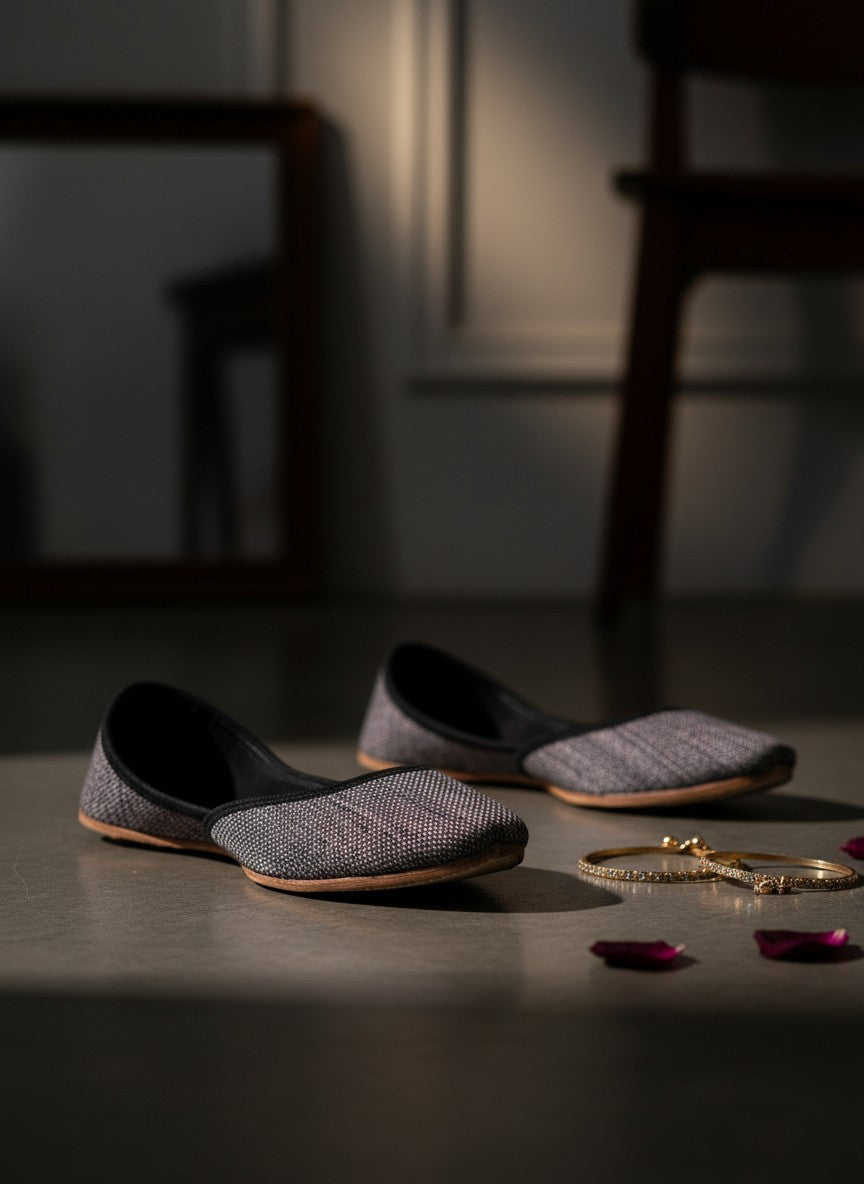 Ujaala Isha grey jutti with textured fabric and black velvet trim. Handcrafted flat shoe.