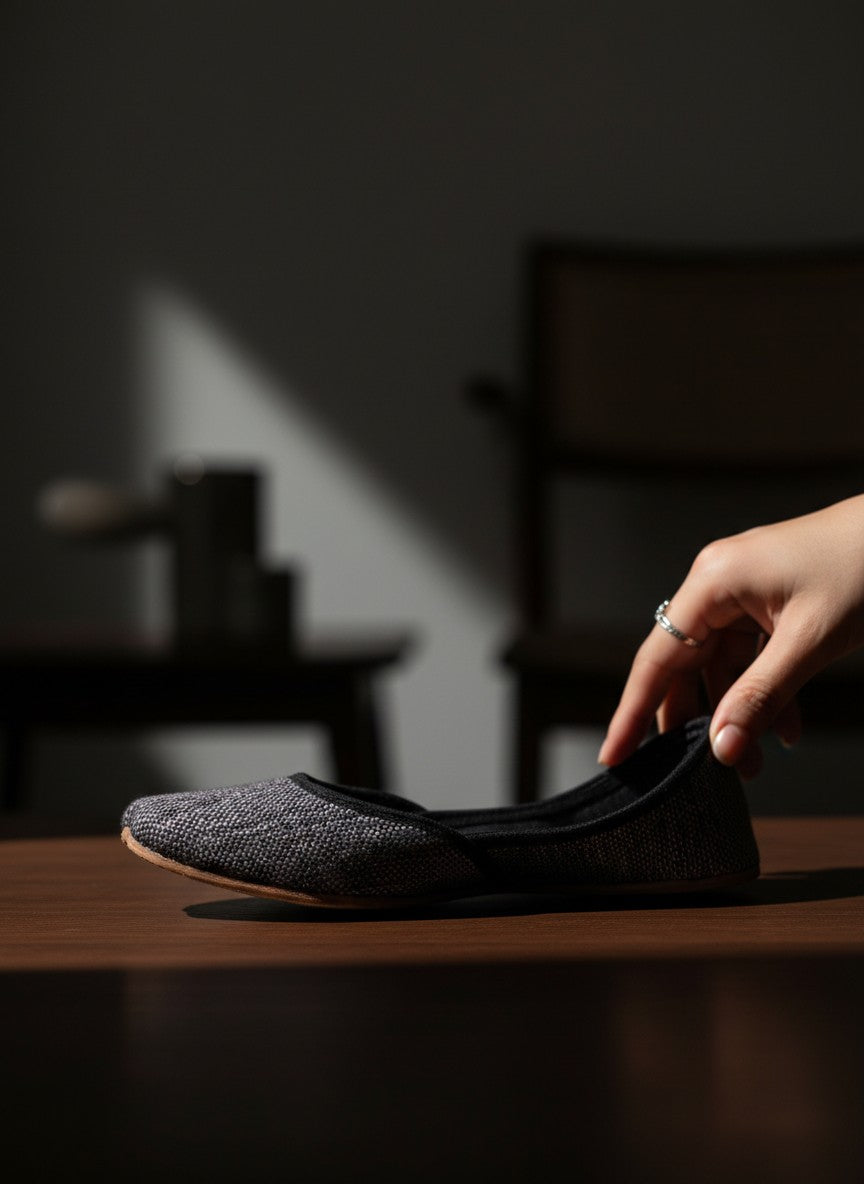 Ujaala Isha grey jutti with textured fabric and black velvet trim. Elegant, handcrafted flat shoe.