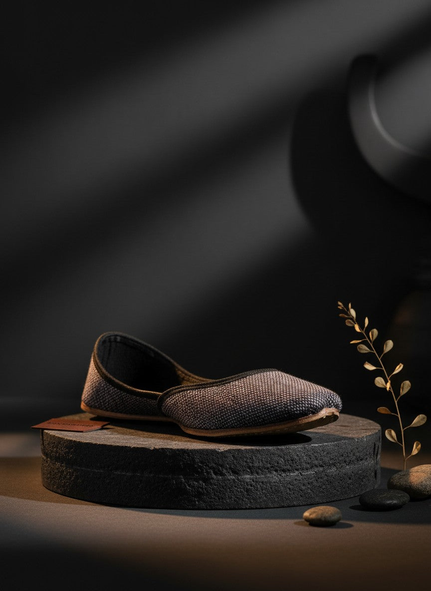 Ujaala Isha grey jutti with textured fabric and black velvet trim. Handcrafted flat shoe.