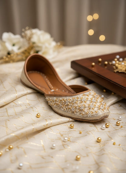 Ujaala Piyu ivory velvet khussa flat shoes with pearl and gold bead embroidery.