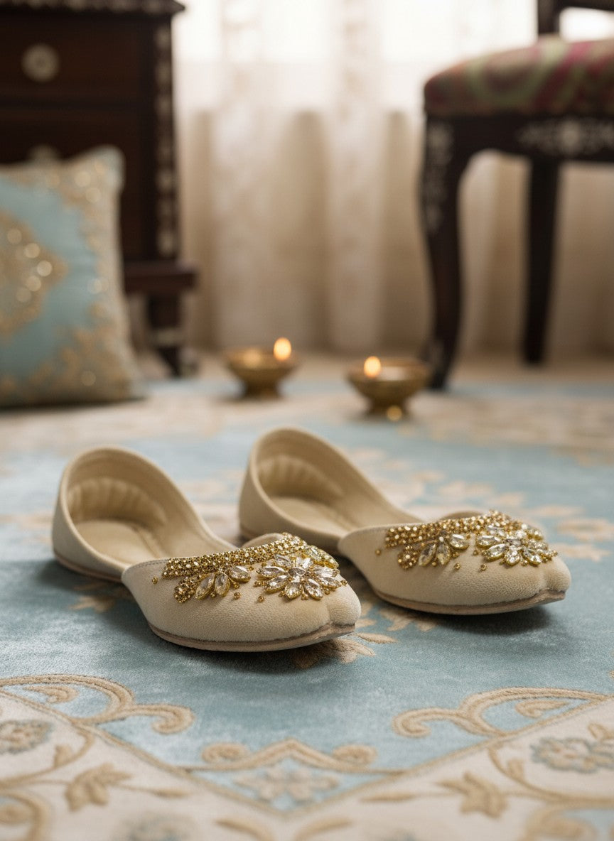 Ujaala Maharani cream jutti embellished with gold beads and clear crystals in a floral design.