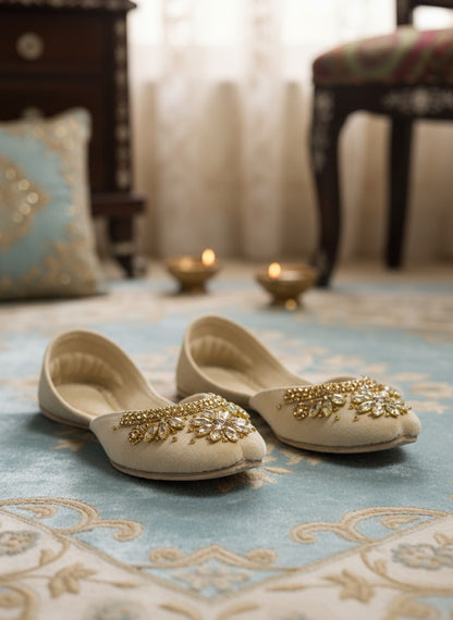 Ujaala Maharani cream jutti embellished with gold beads and clear crystals in a floral design.