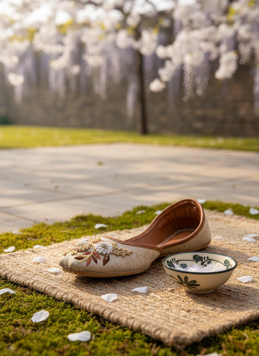 Ujaala Naazneen beige jutti with gold and ivory floral embroidery. Comfortable flat shoes for festive occasions.