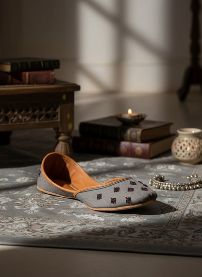 Ujaala Nawabi grey jutti with beaded embellishments and tan leather lining.