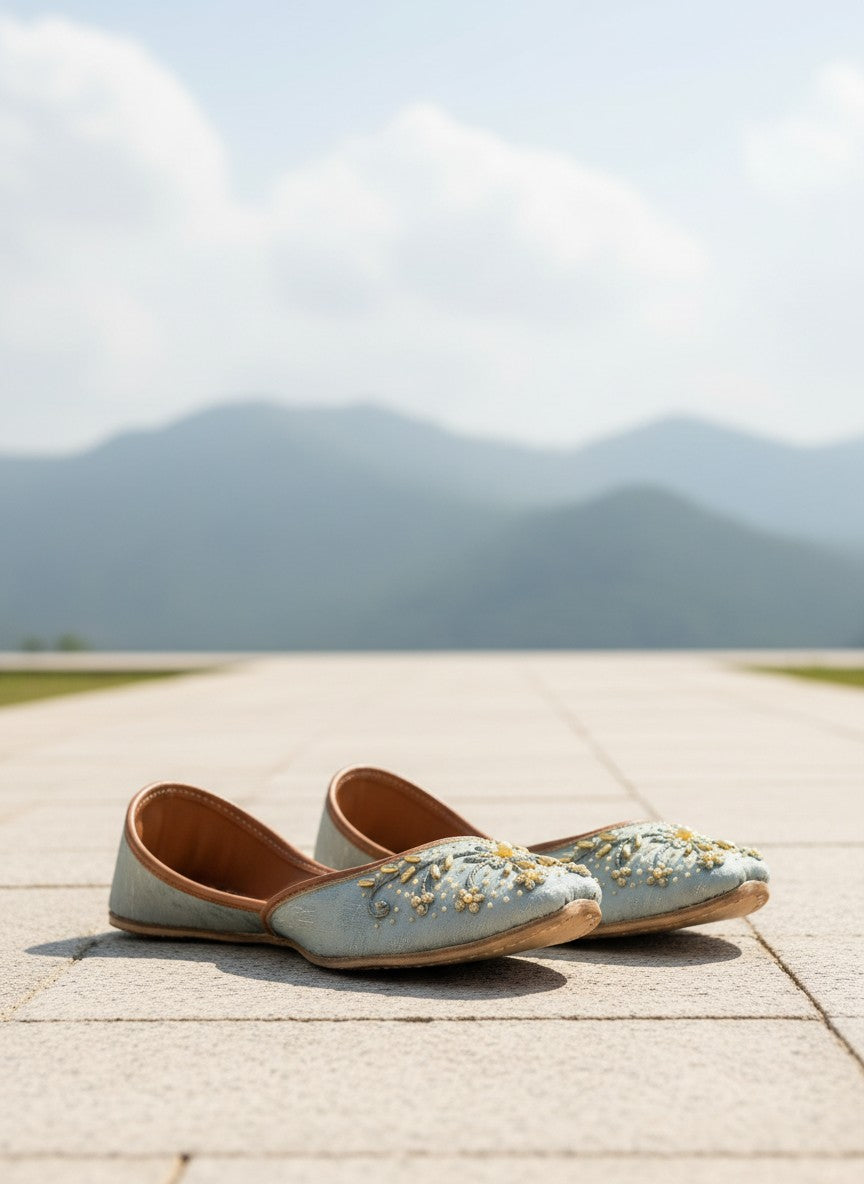 Ujaala pastel blue jutti with gold embroidery and pearl accents. Festive flat shoe.