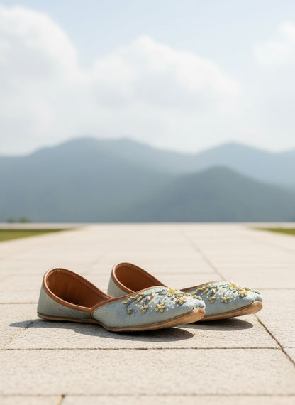Ujaala pastel blue jutti with gold embroidery and pearl accents. Festive flat shoe.