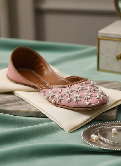Ujaala Roshanayat pink jutti embellished with pearls and beads, featuring a pointed toe and traditional Indian design.