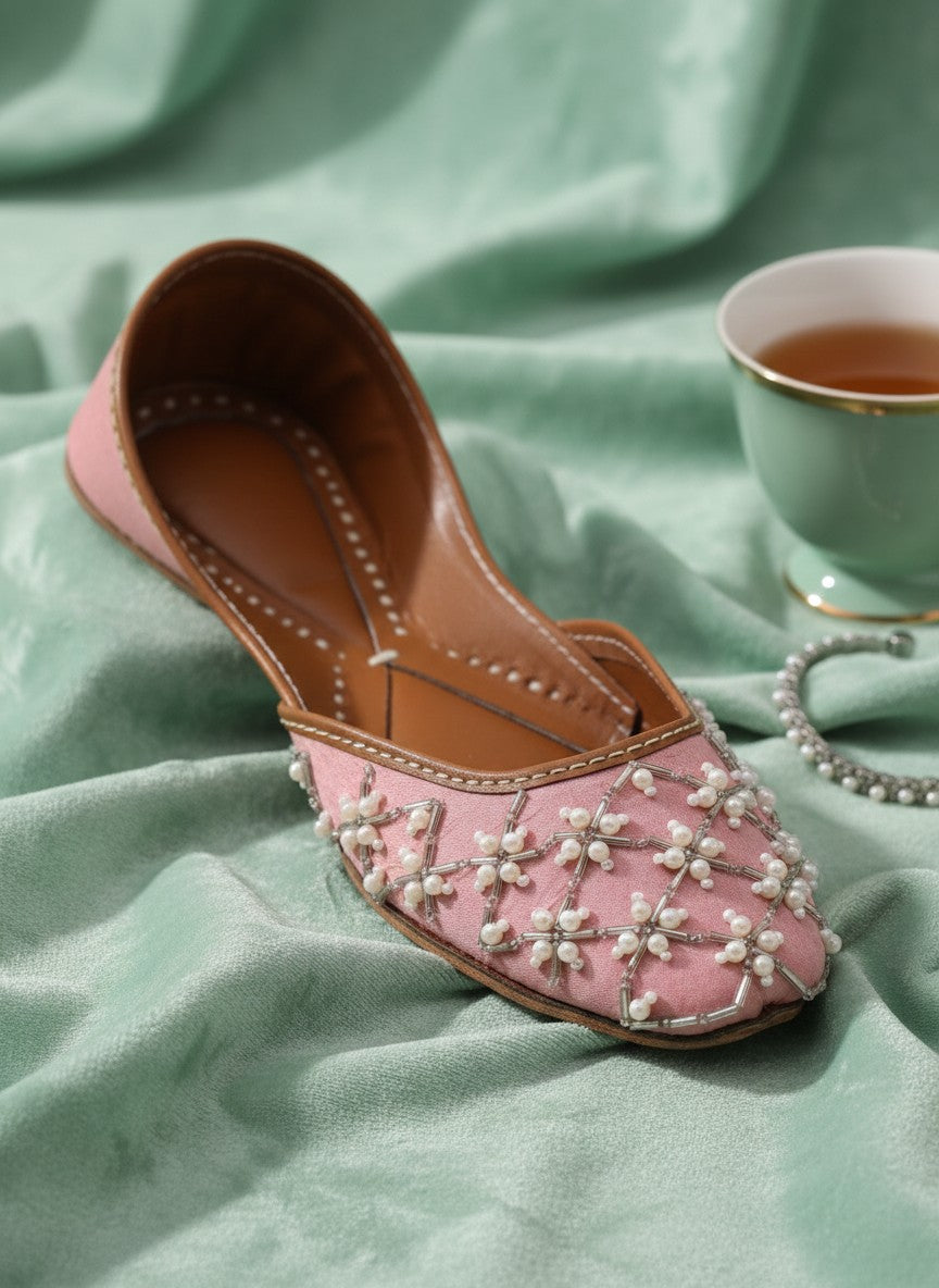 Ujaala Roshanayat pink jutti embellished with pearls and beads, featuring a pointed toe and flat sole.