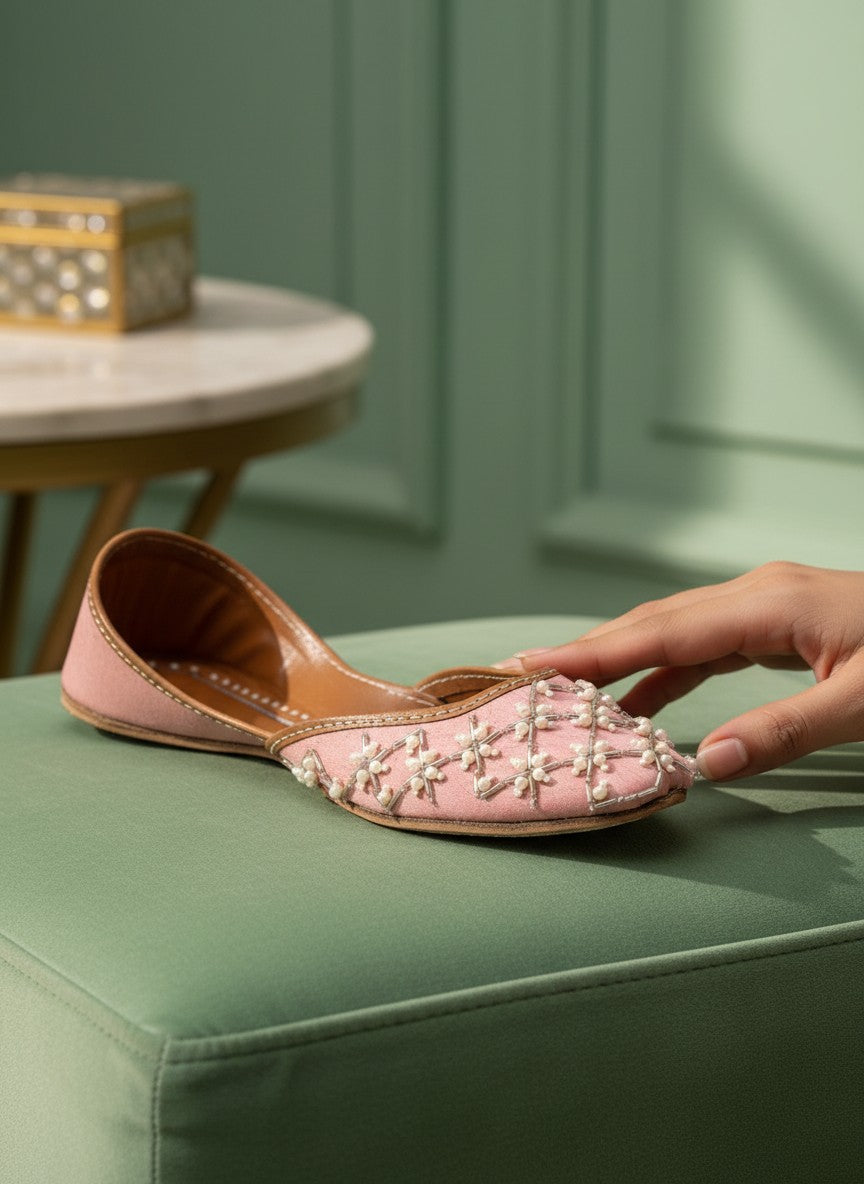 Ujaala Roshanayat pink jutti embellished with pearls and beads, featuring a pointed toe and flat sole.