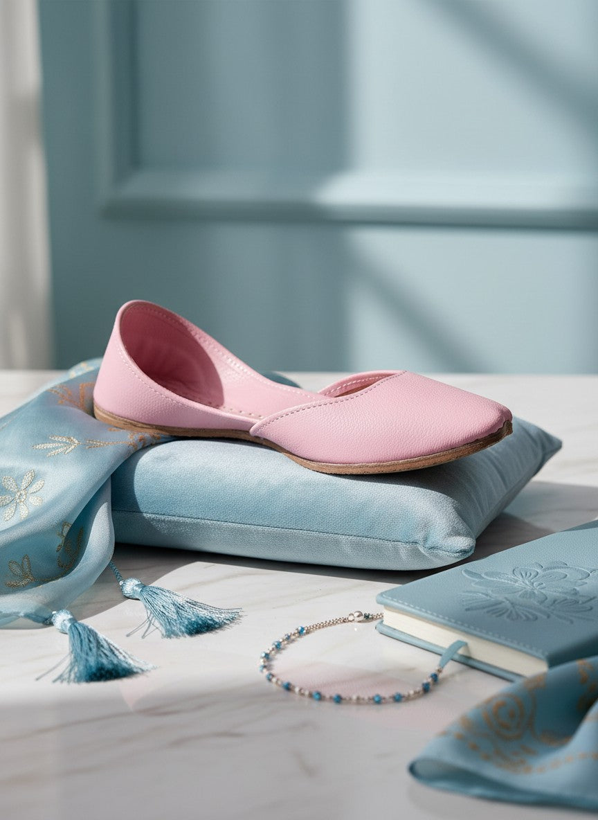 Ujaala Noora pink plain leather jutti with a pointed toe and flat sole.