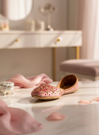 Ujaala Sapna pink velvet jutti with gold embroidery and bead accents. Handcrafted festive footwear.