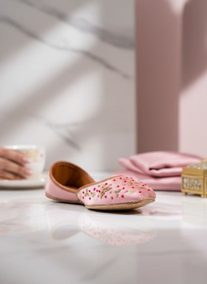 Ujaala Sapna pink velvet jutti with gold embroidery and bead accents. Handcrafted festive footwear.