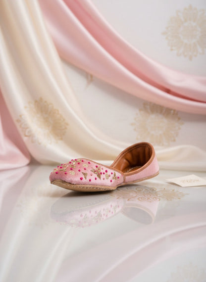 Ujaala Sapna pink velvet jutti with gold embroidery and bead accents. Handcrafted festive footwear.