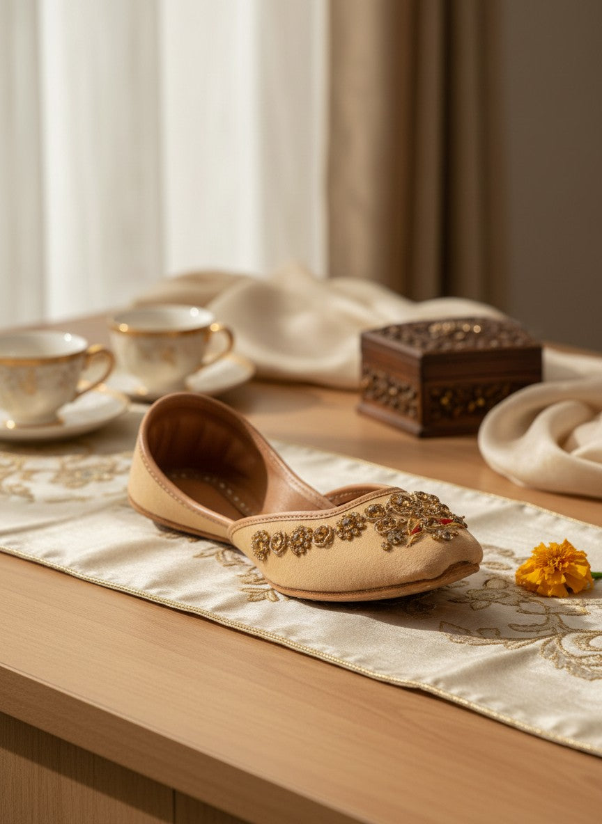 Ujaala Rangeen Kali beige velvet jutti with intricate gold and crystal embellishments on the toe.