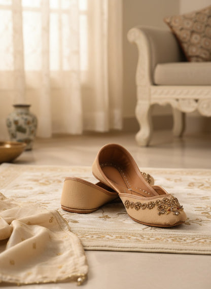 Ujaala Rangeen Kali beige velvet jutti with intricate gold and crystal embellishments.