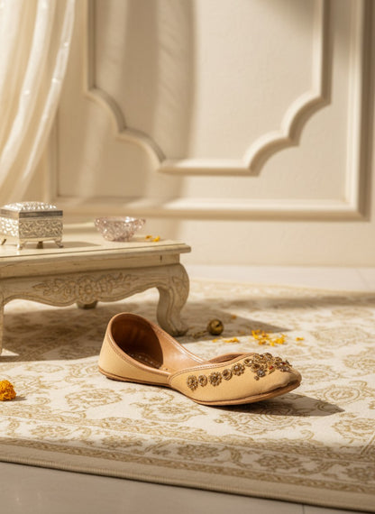 Ujaala Rangeen Kali beige velvet jutti with intricate gold and crystal embellishments.