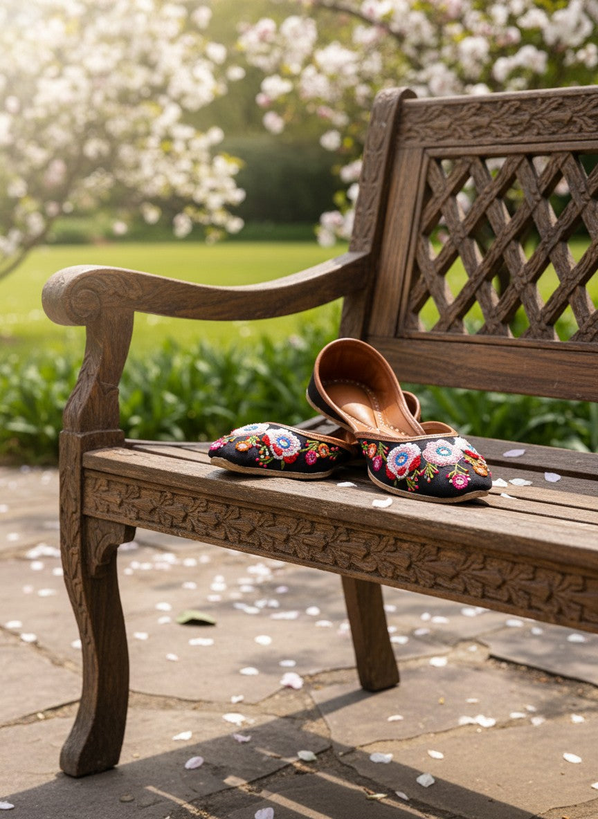 Ujaala Rangrez black handcrafted khussa with vibrant floral embroidery and bead detailing.