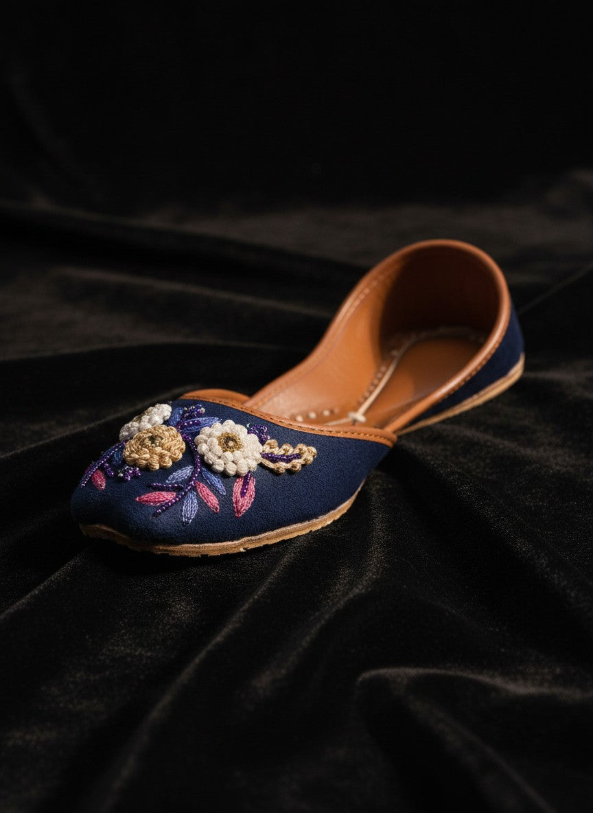 Ujaala Naazneen royal blue velvet jutti with floral bead embroidery and leather sole.