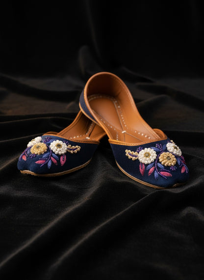 Ujaala Naazneen royal blue velvet jutti with floral bead embroidery and leather sole.