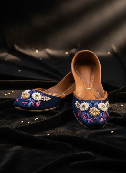 Ujaala Naazneen royal blue velvet jutti with floral bead embroidery and leather sole.
