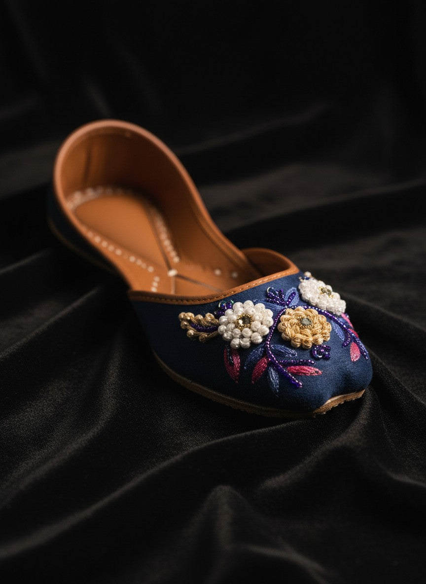 Ujaala Naazneen royal blue velvet jutti with floral bead embroidery and leather sole.