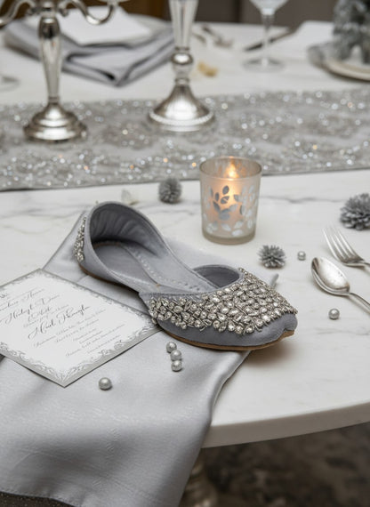 Ujaala Aurora silver velvet jutti embellished with clear crystals and beads. Elegant flat shoe for women.
