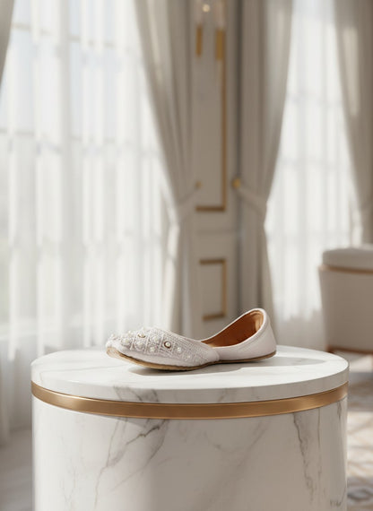 Ujaala Nayaab white jutti embellished with pearls and intricate beadwork. Traditional flat shoe for women.