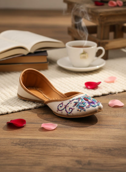 Ujaala Zari white jutti with intricate floral embroidery in blue, purple, and pink beads.
